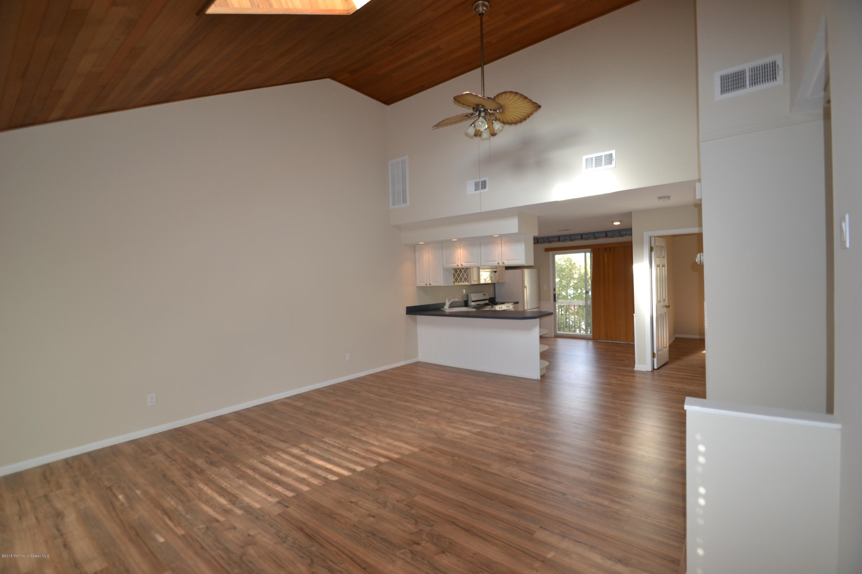 1212 Beaver Dam Road, Unit 14 Point Pleasant, NJ 08742 - Photo 2 of 14 a view of kitchen and dining room with wooden floor