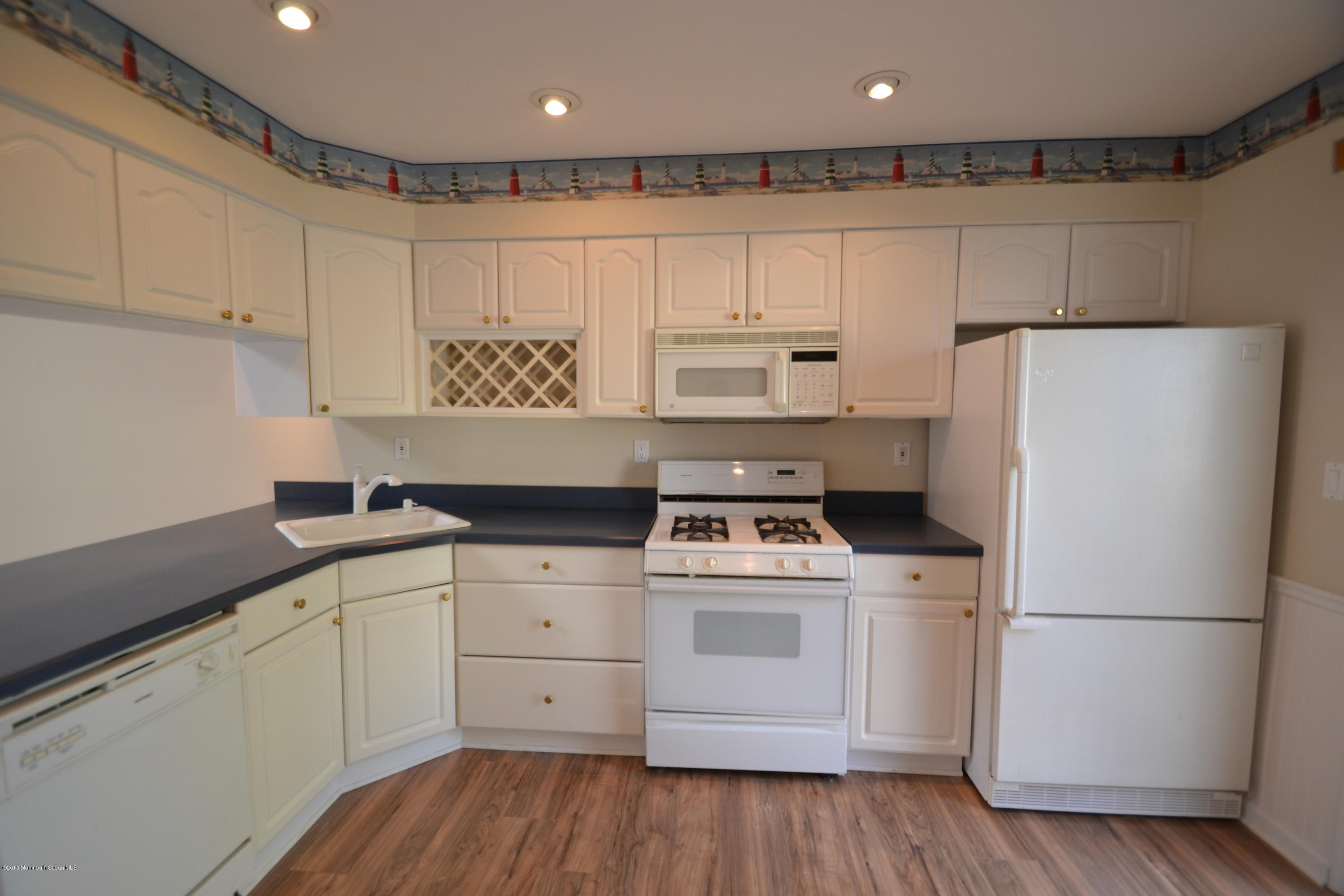 1212 Beaver Dam Road, Unit 14 Point Pleasant, NJ 08742 - Photo 6 of 14 a kitchen with a white cabinets and white appliances