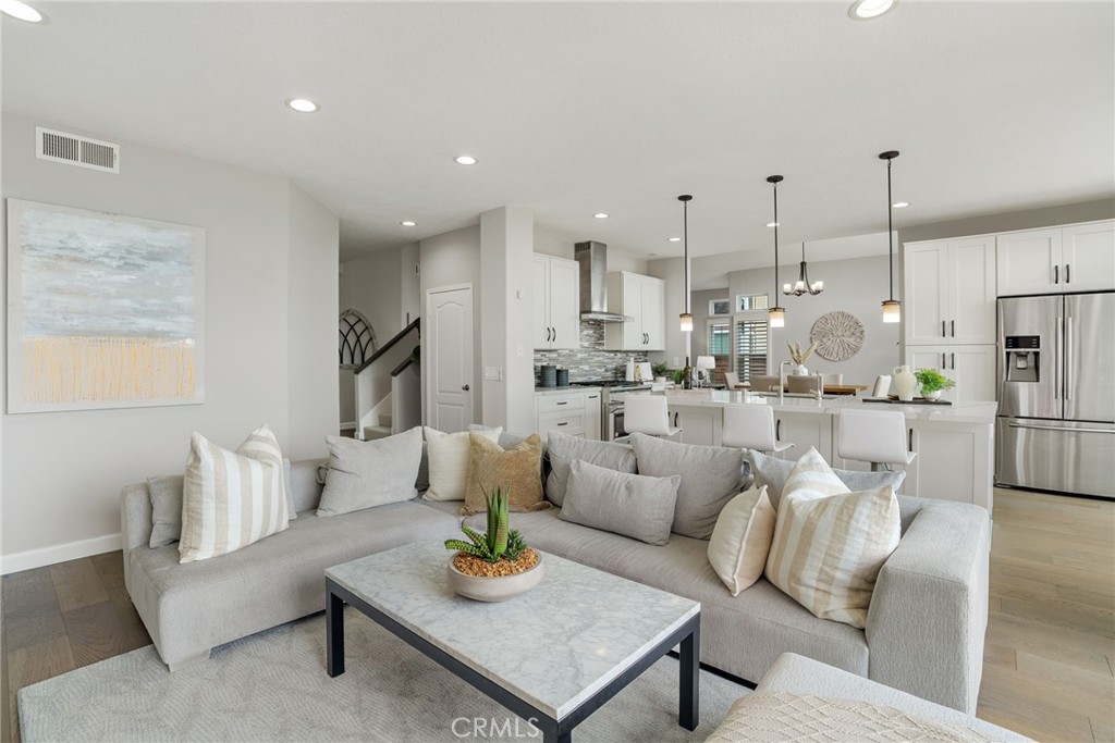 29632 Alta Terra Laguna Niguel, CA 92677 - Photo 17 of 37 a living room with furniture kitchen view and a chandelier