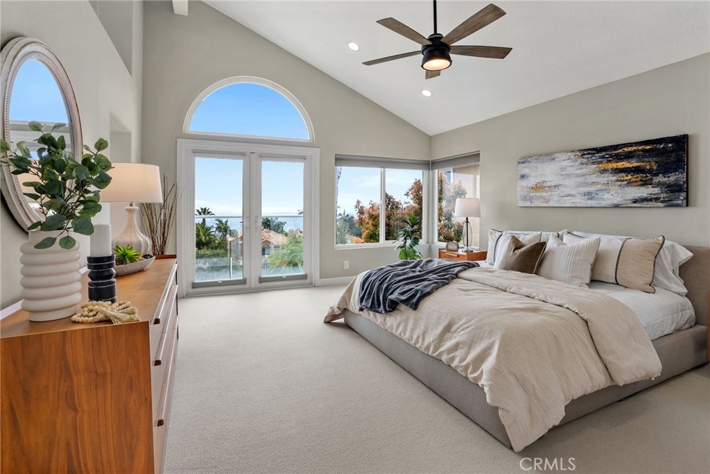 29632 Alta Terra Laguna Niguel, CA 92677 - Photo 22 of 37 a spacious bedroom with a large bed and a chandelier