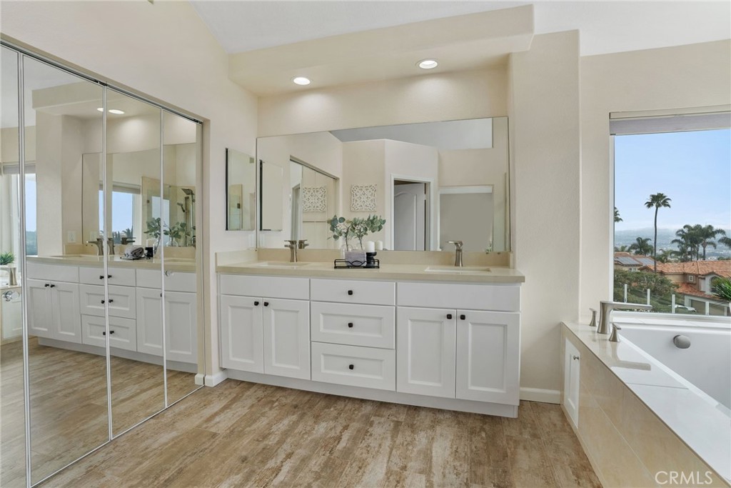 29632 Alta Terra Laguna Niguel, CA 92677 - Photo 24 of 37 a spacious bathroom with double vanity a mirror a bathtub and double vanity