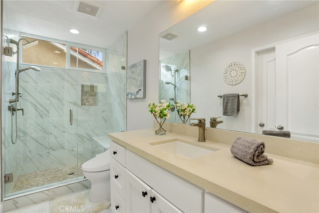 29632 Alta Terra Laguna Niguel, CA 92677 - Photo 28 of 37 a bathroom with a double vanity sink mirror and shower
