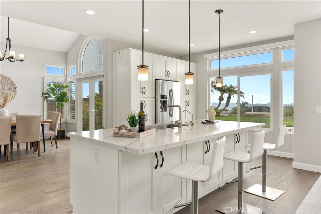 29632 Alta Terra Laguna Niguel, CA 92677 - Photo 4 of 37 a room with stainless steel appliances kitchen island granite countertop a table chairs and a view of living room