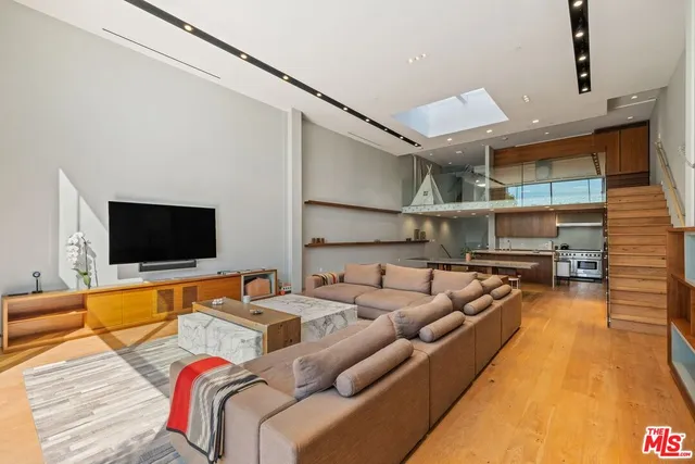 a living room with furniture pool and flat screen tv