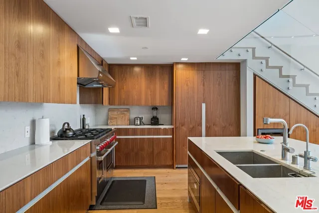 a kitchen that has a sink and a stove in it