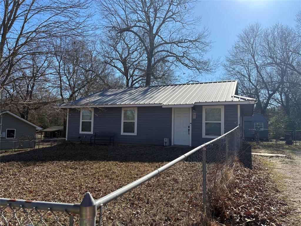 51 County Road Paris, TX 75460 - Photo 1 of 16 a view of a house with a large tree next to a yard