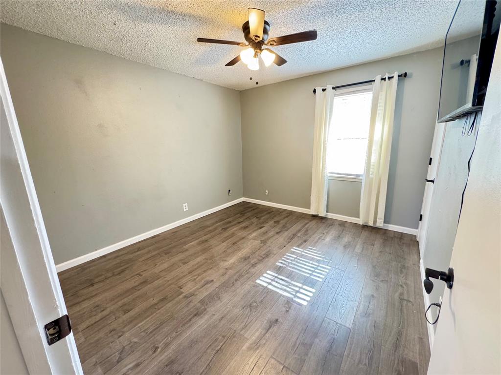 51 County Road Paris, TX 75460 - Photo 11 of 16 an empty room with wooden floor and windows