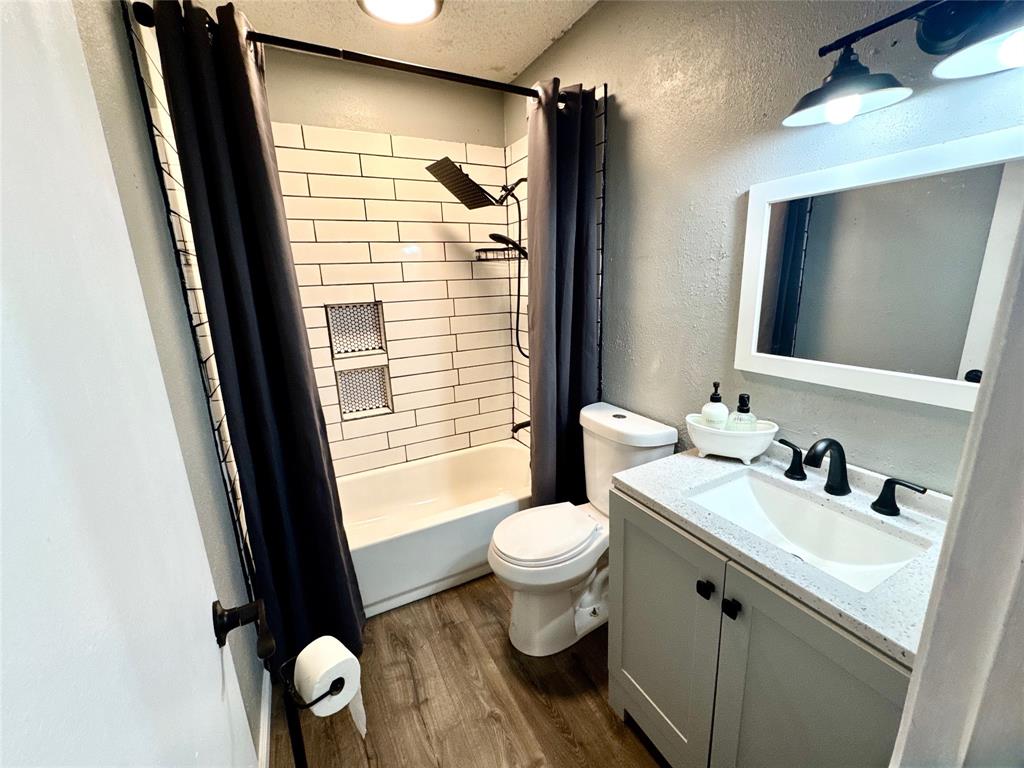 51 County Road Paris, TX 75460 - Photo 12 of 16 a bathroom with a sink a toilet a mirror and window