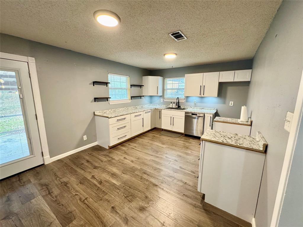 51 County Road Paris, TX 75460 - Photo 5 of 16 a kitchen with stainless steel appliances granite countertop a stove a sink and a refrigerator
