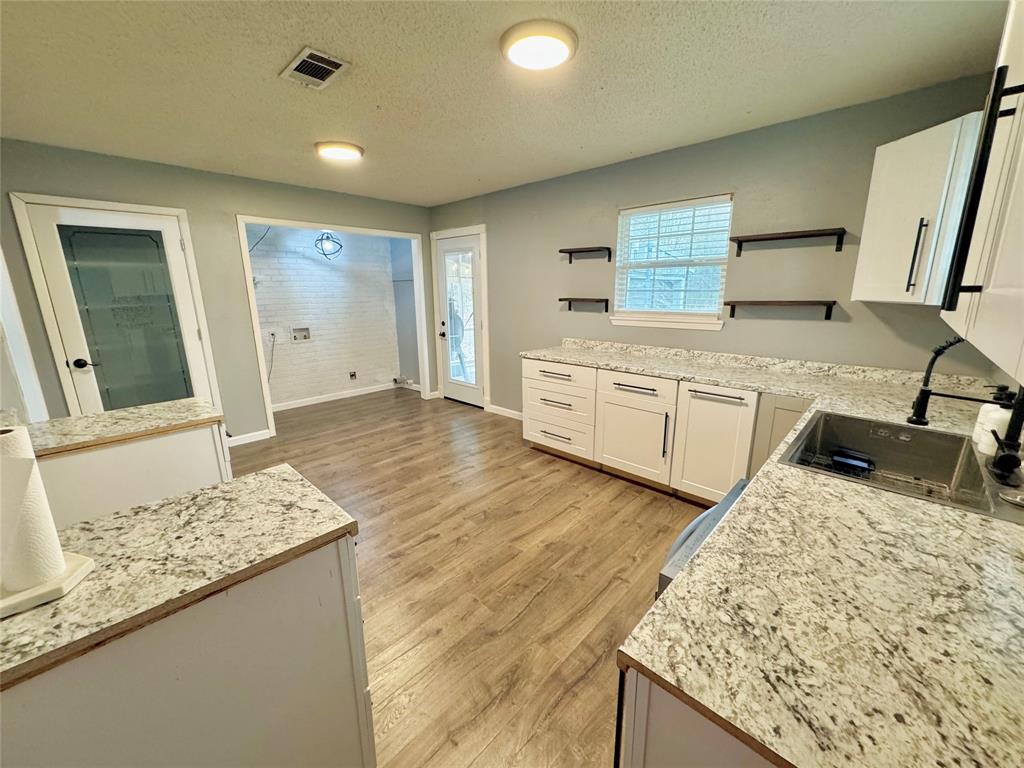 51 County Road Paris, TX 75460 - Photo 7 of 16 a kitchen with stainless steel appliances granite countertop sink and wooden cabinets