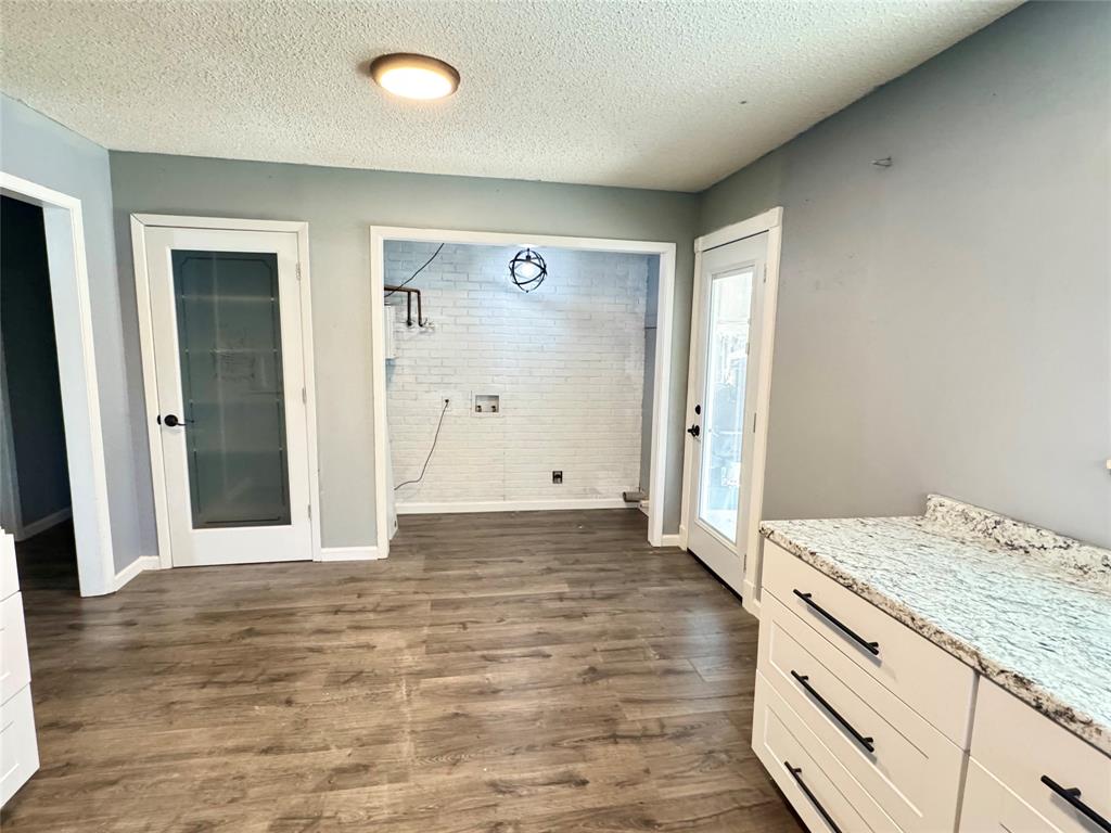 51 County Road Paris, TX 75460 - Photo 7 of 16 an empty room with wooden floor and bathroom