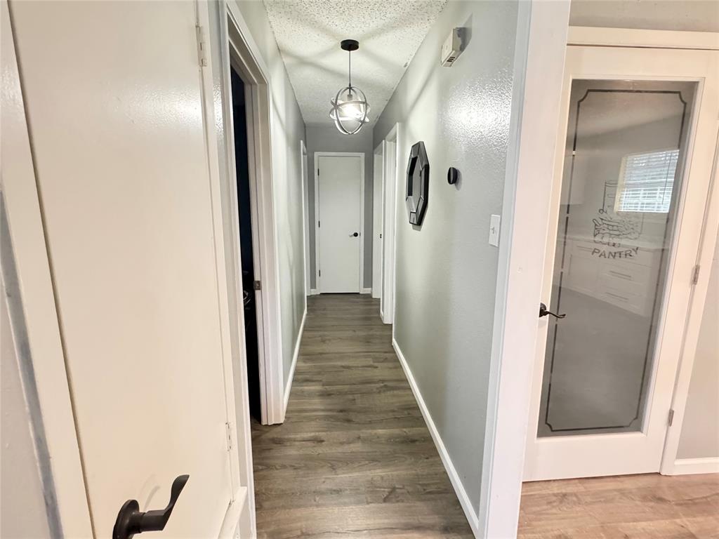 51 County Road Paris, TX 75460 - Photo 8 of 16 a view of a hallway with wooden floor and mirror