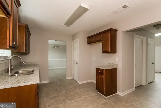 a bathroom with a sink double vanity and granite