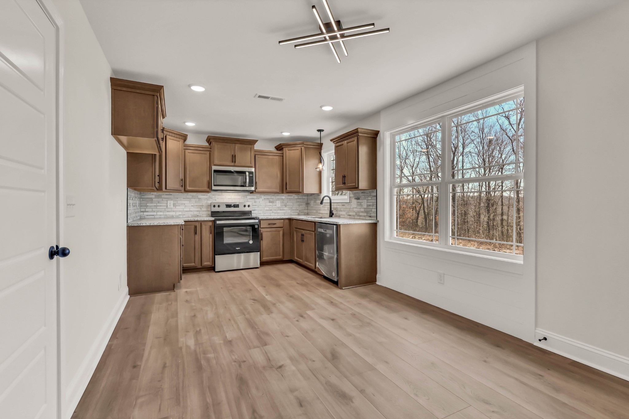 864 Burley Barn Road Clarksville, TN 37042 - Photo 6 of 24 a kitchen with stainless steel appliances granite countertop a stove top oven a sink and a refrigerator