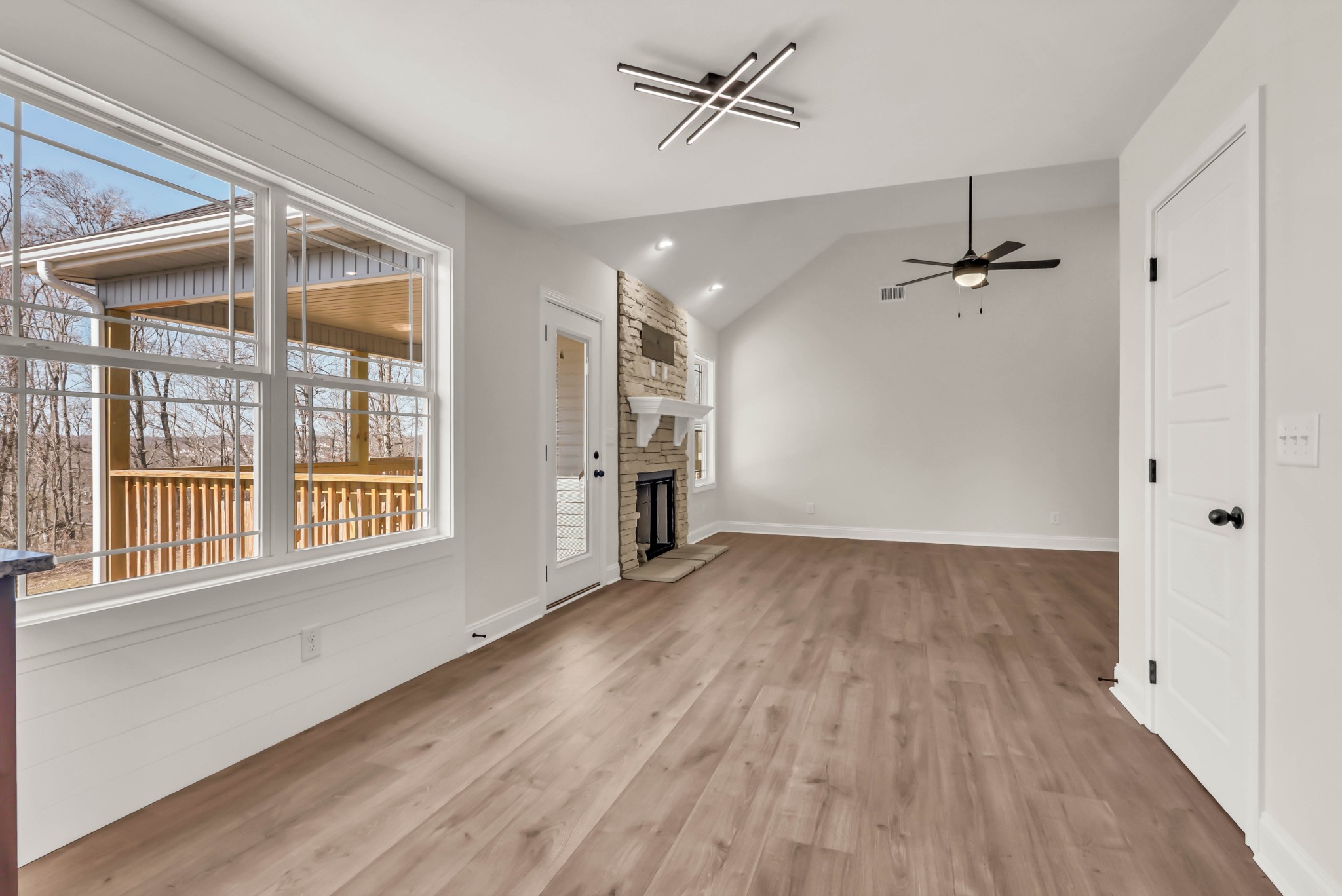 864 Burley Barn Road Clarksville, TN 37042 - Photo 7 of 24 a view of an empty room with a window and wooden floor