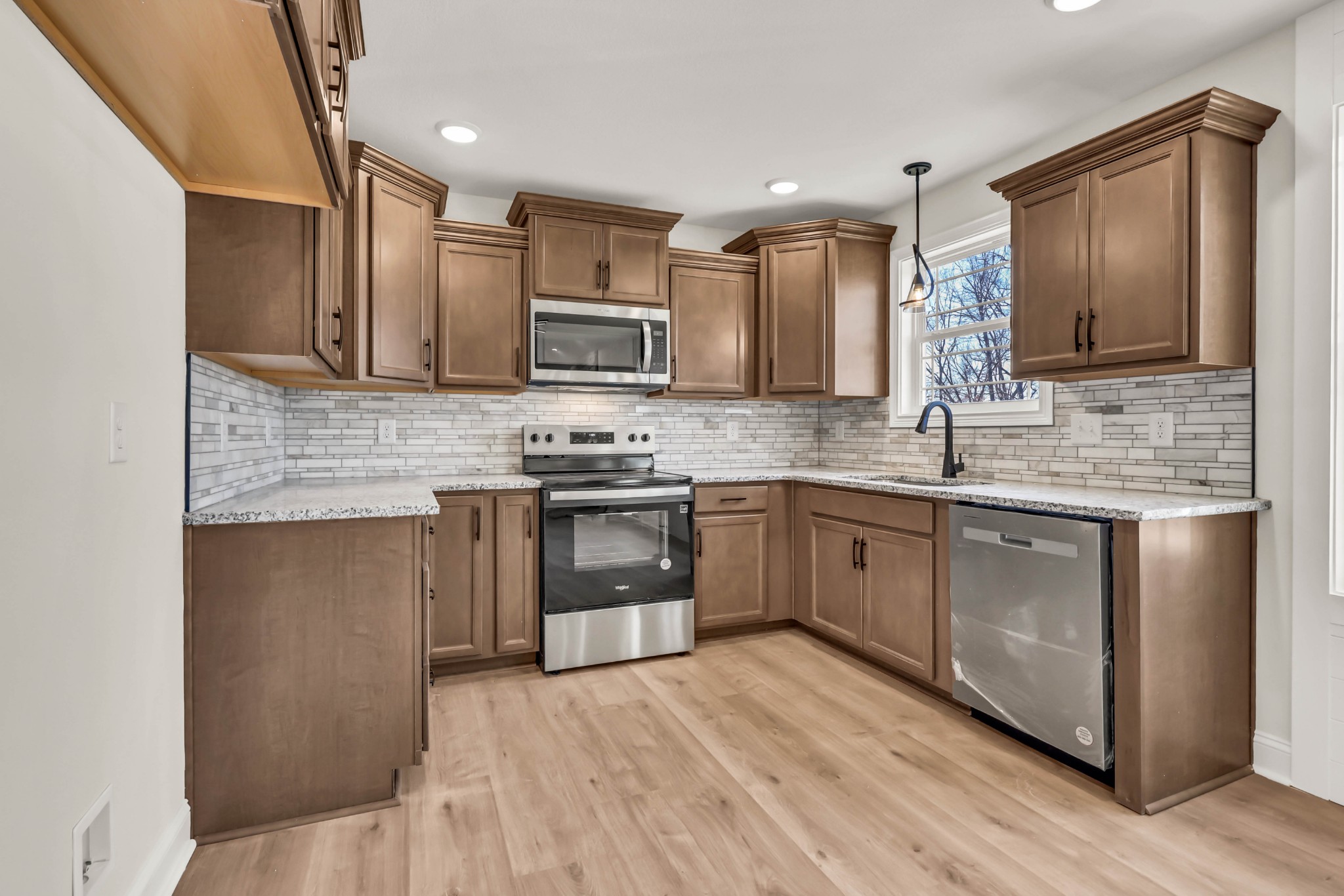 864 Burley Barn Road Clarksville, TN 37042 - Photo 8 of 24 a kitchen with stainless steel appliances granite countertop a stove sink and cabinets