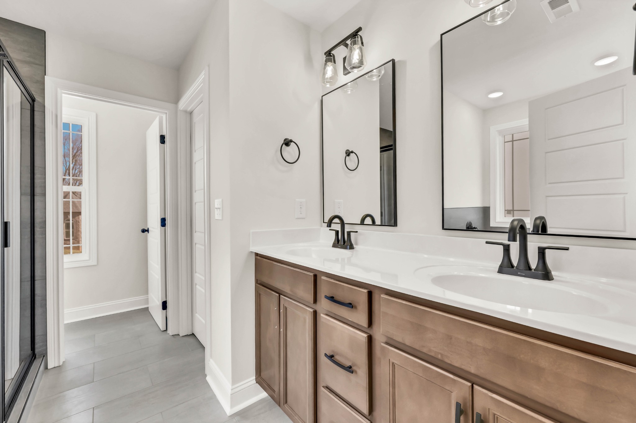 864 Burley Barn Road Clarksville, TN 37042 - Photo 10 of 24 a bathroom with a double vanity sink a mirror and shower