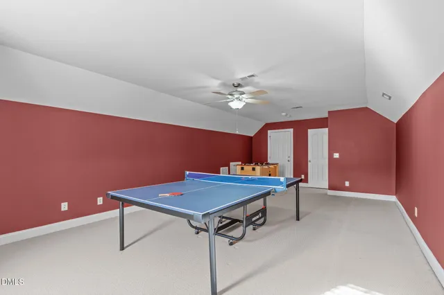a room with table chairs and wooden floor