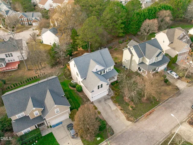 an aerial view of a house with a yard and lake view
