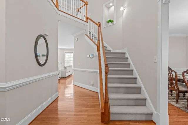 a view of entryway and hall with wooden floor