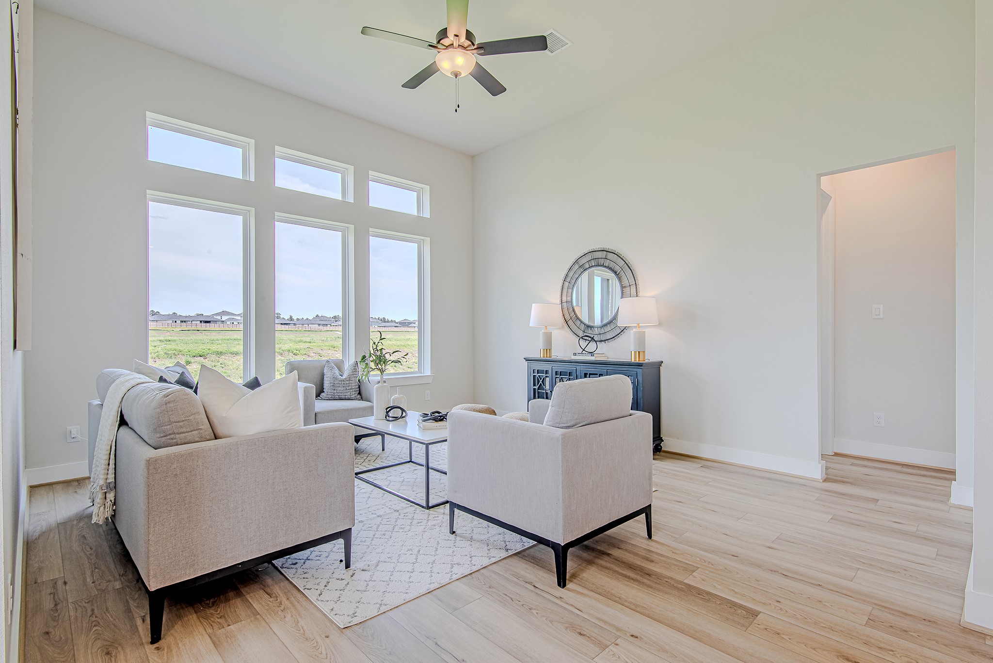 141 Peninsula Point Drive Montgomery, TX 77356 - Photo 16 of 47 Relax in a sun-drenched living room with soaring ceilings and a wall of windows that capture peaceful neighborhood and water views.