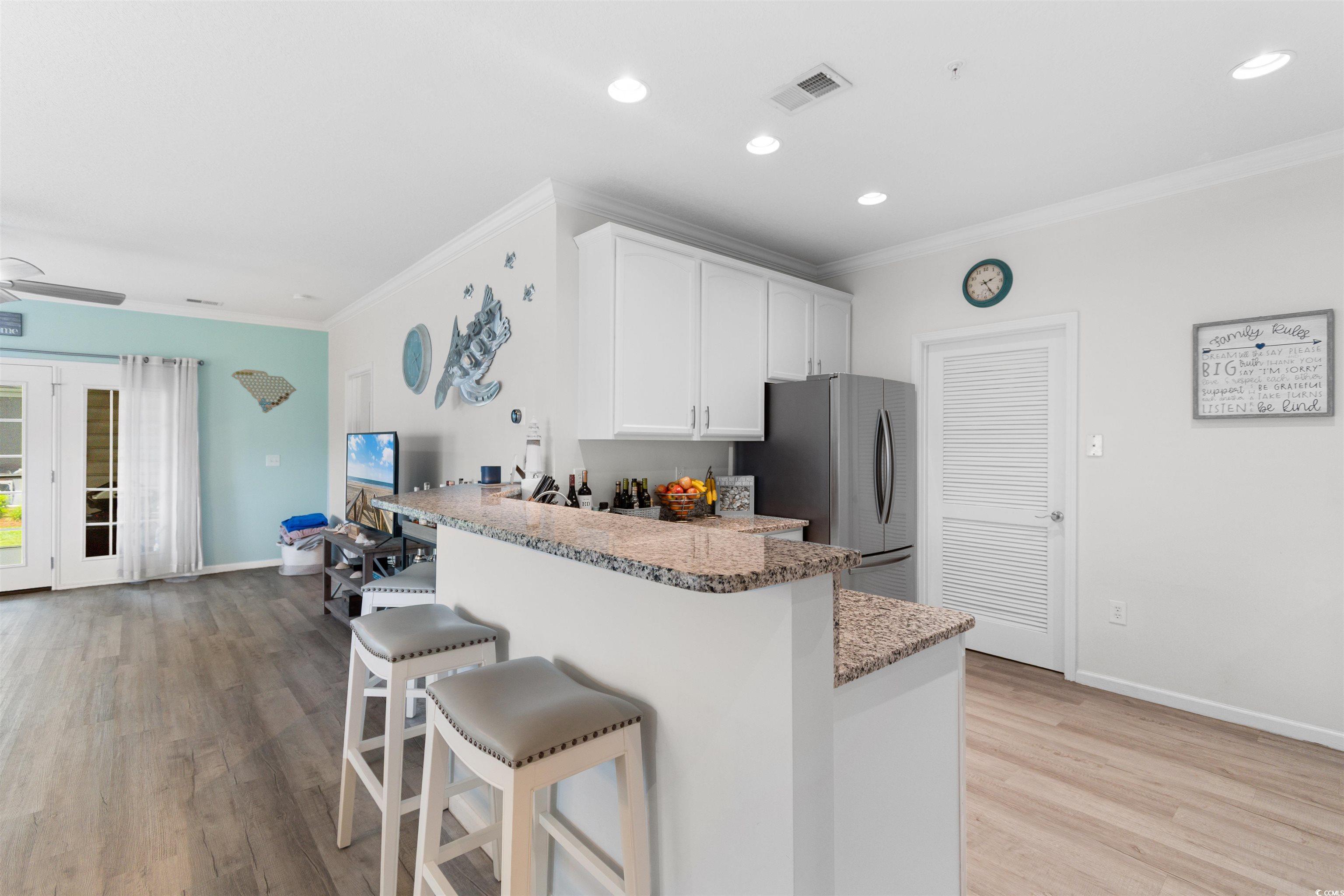 411 Mahogany Drive, Unit 101 Murrells Inlet, SC 29576 - Photo 8 of 27 Kitchen featuring freestanding refrigerator, a bre