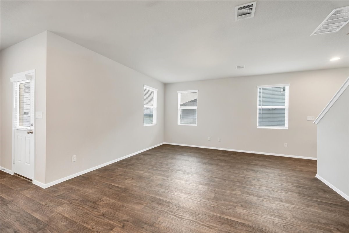 116 Honeybee Lane Elgin, TX 78621 - Photo 15 of 37 an empty room with wooden floor and windows