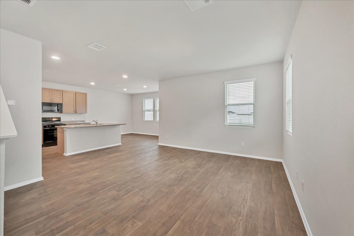 116 Honeybee Lane Elgin, TX 78621 - Photo 16 of 37 a view of kitchen with wooden floor and windows