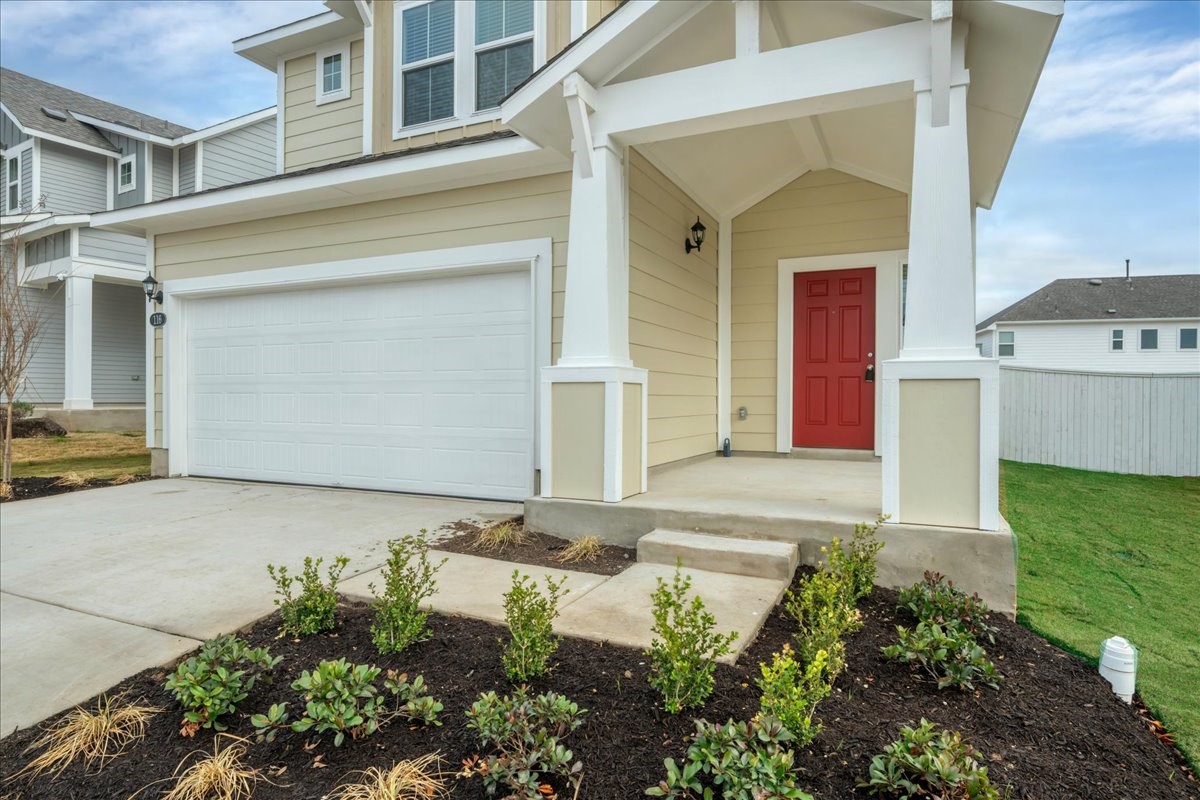 116 Honeybee Lane Elgin, TX 78621 - Photo 2 of 37 a front view of a house with garden
