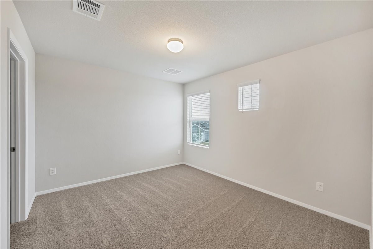 116 Honeybee Lane Elgin, TX 78621 - Photo 24 of 37 an empty room with windows