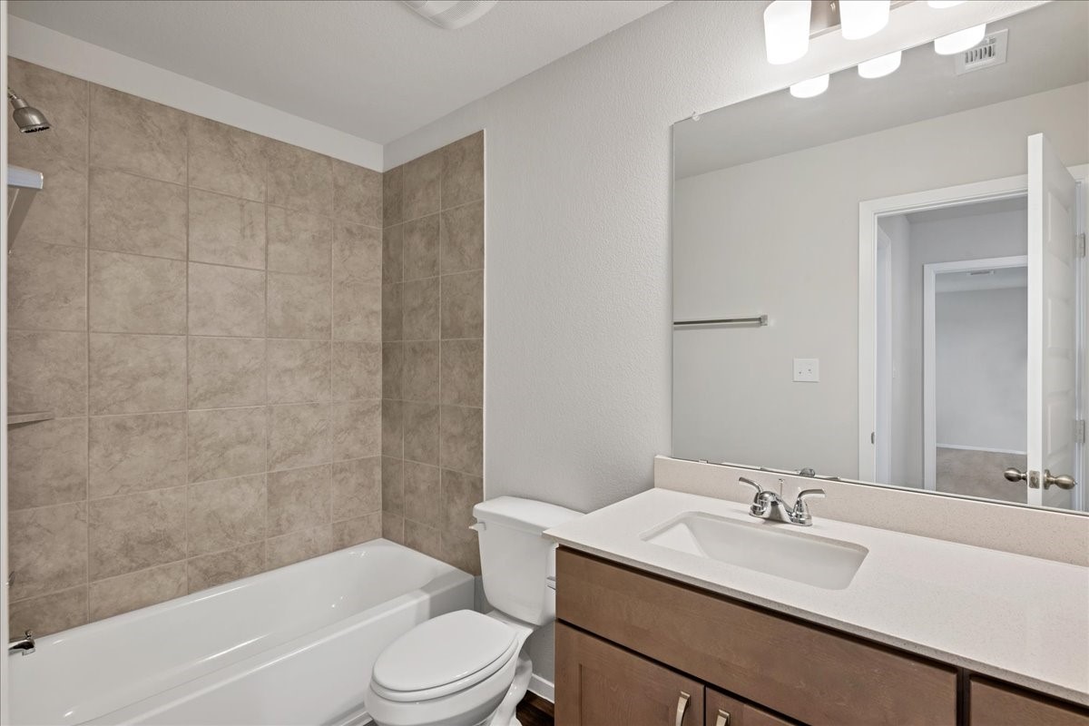 116 Honeybee Lane Elgin, TX 78621 - Photo 28 of 37 a bathroom with a sink a toilet and shower