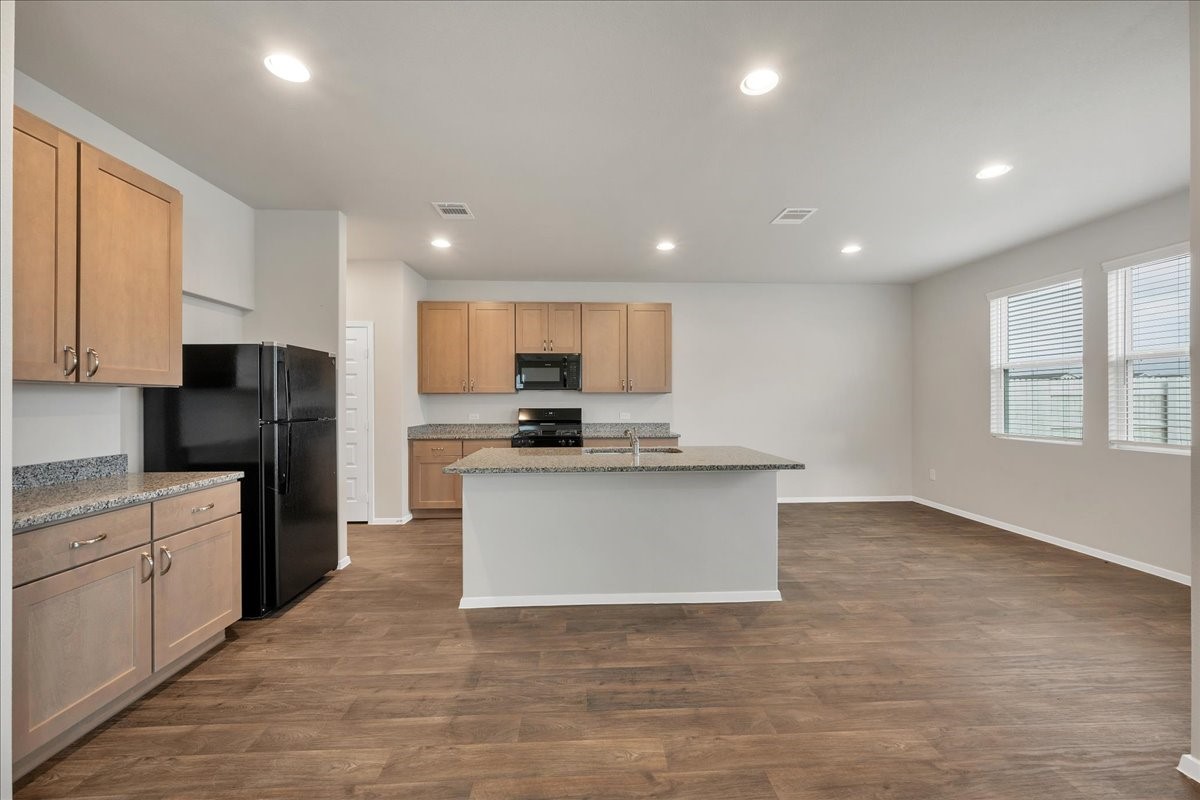 116 Honeybee Lane Elgin, TX 78621 - Photo 8 of 37 a kitchen with granite countertop white cabinets and stainless steel appliances
