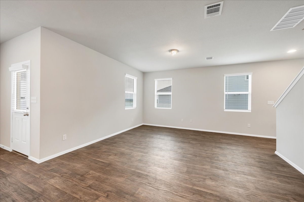 116 Honeybee Lane Elgin, TX 78621 - Photo 10 of 37 an empty room with wooden floor and windows