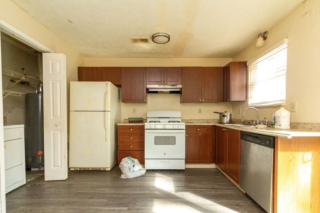 8654 Ashley Way Douglasville, GA 30134 - Photo 3 of 8 a kitchen with a refrigerator and a stove