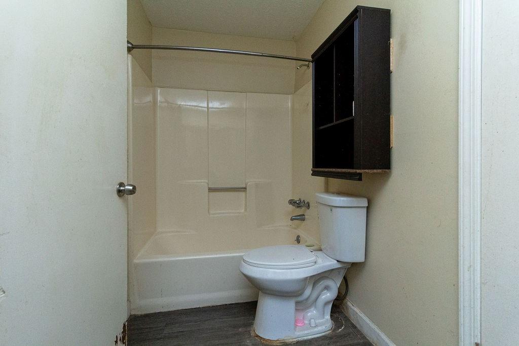 8654 Ashley Way Douglasville, GA 30134 - Photo 7 of 8 a bathroom with a toilet and a shower