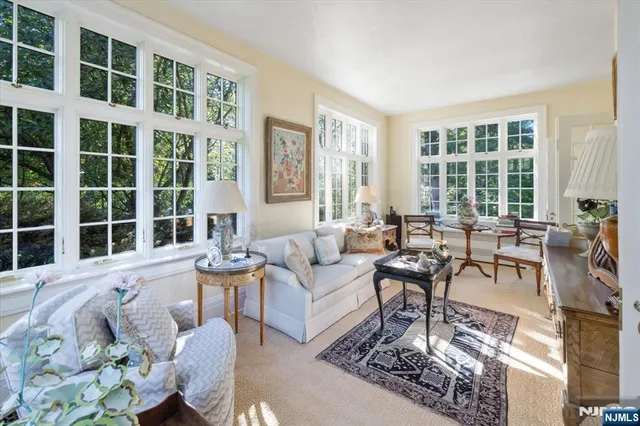 a living room with furniture and large windows