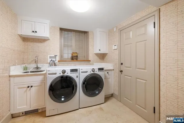 a utility room with sink dryer and washer