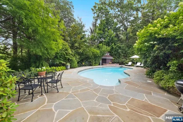 a view of a swimming pool with a table and chairs