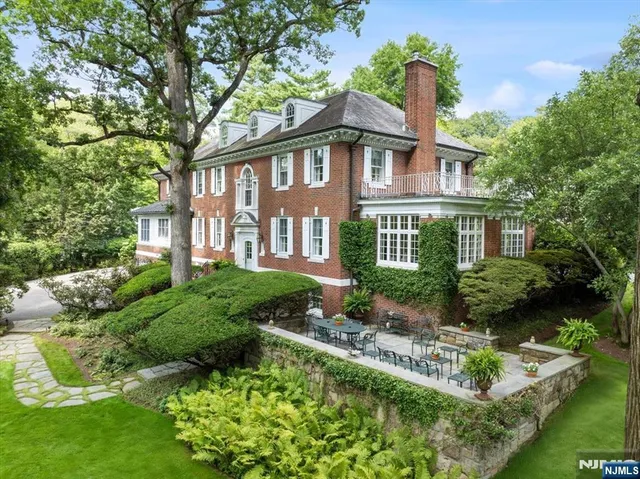 a front view of a house with a yard table and chairs
