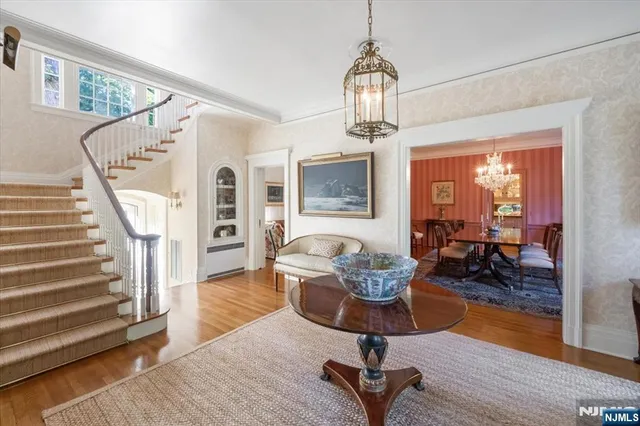 a living room with furniture and a chandelier