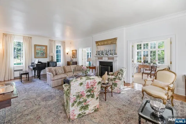 a living room with furniture fireplace and a table
