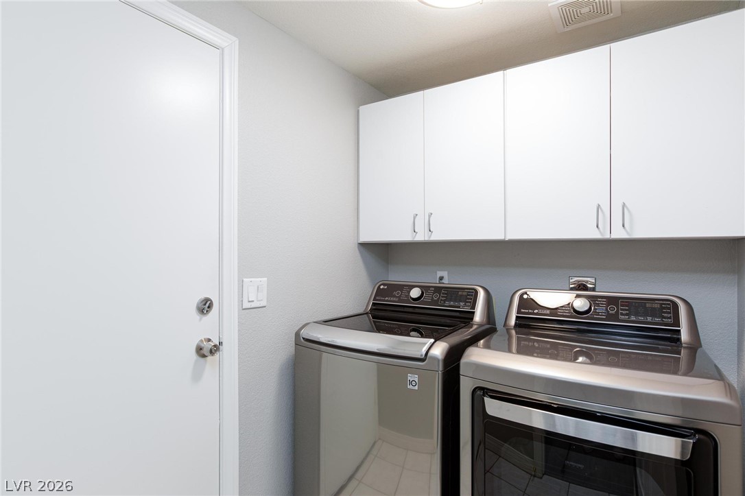 2254 Ramsgate Drive Henderson, NV 89074 - Photo 24 of 43 Streamlined laundry area with a matching washer and dryer, complemented by crisp white cabinetry.