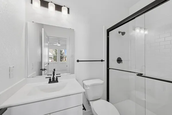 a kitchen with stainless steel appliances granite countertop a stove a refrigerator a oven a sink a dining table and chairs with wooden floor