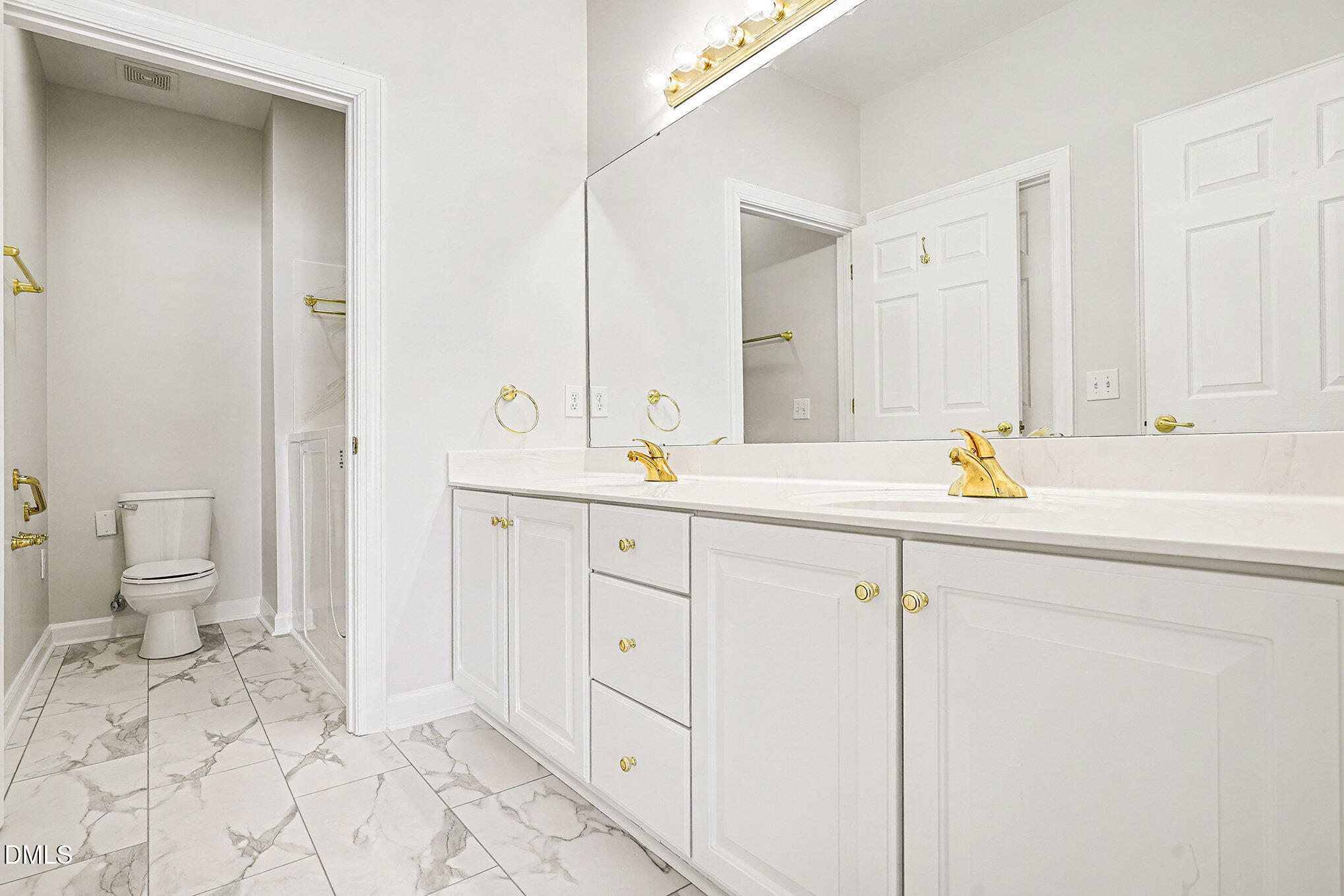 4703 Lewisham Court Raleigh, NC 27612 - Photo 15 of 27 a bathroom with a sink a toilet and a mirror