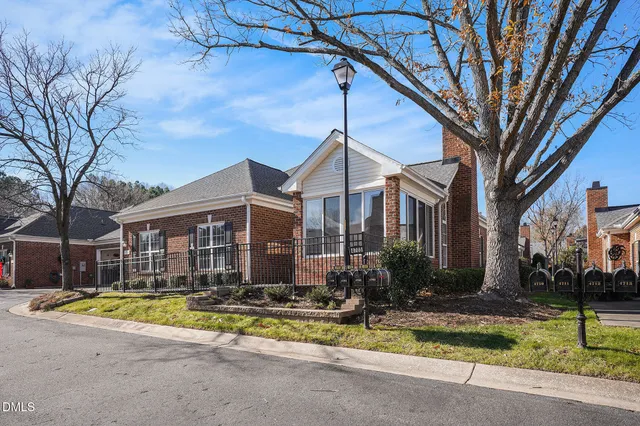 a view of a house with swimming pool next to a yard
