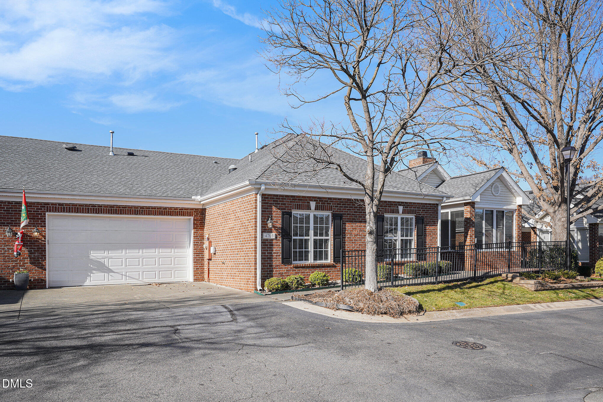 4703 Lewisham Court Raleigh, NC 27612 - Photo 4 of 27 a view of a white house with a large tree and many windows