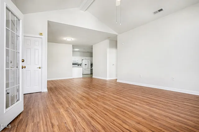 a view of empty room with wooden floor
