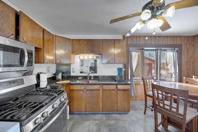 a kitchen with stainless steel appliances granite countertop a stove and a sink