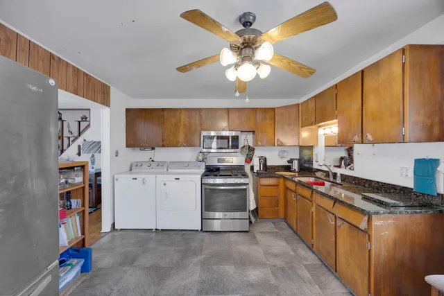 a bathroom with a granite countertop sink a toilet and a mirror