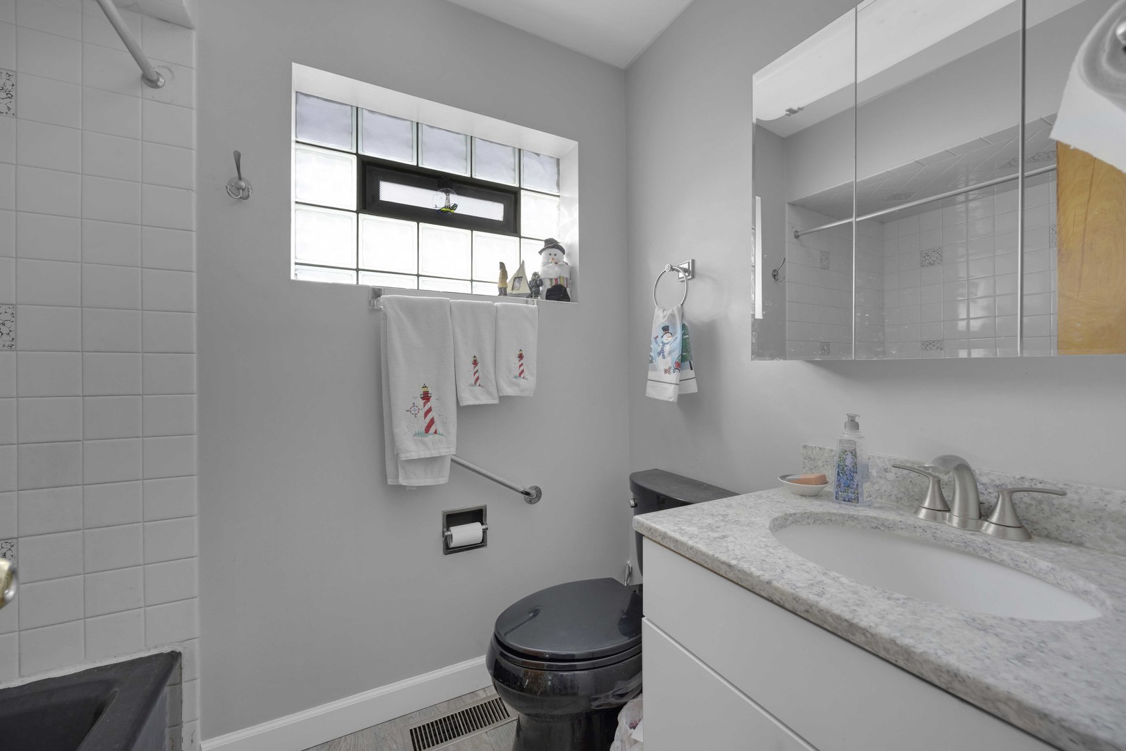 7101 Birch Street Bridgeview, IL 60455 - Photo 14 of 18 a bathroom with a granite countertop sink a toilet and a mirror